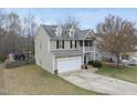 Aerial view of a two-story home with a two-car garage and a balcony on the front at 416 Collinsworth Dr, Clayton, NC 27527