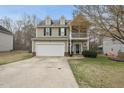 Charming two-story home with a two-car garage and a balcony on the front at 416 Collinsworth Dr, Clayton, NC 27527