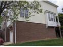 This townhome features a mix of brick and siding, complemented by multiple windows for natural light and rear balcony at 4502 Pale Moss Dr. Dr, Raleigh, NC 27606