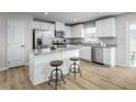 Modern kitchen featuring stainless steel appliances, a kitchen island with seating at 62 Furley St, Sanford, NC 27330