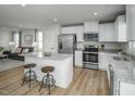 Contemporary kitchen with a large island, stainless steel appliances, and an adjacent living area at 62 Furley St, Sanford, NC 27330