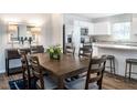 Dining area with wood table, chairs, and view to the kitchen with stainless steel appliances at 700 Port Charlotte Ct, Sanford, NC 27330