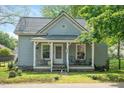 Quaint home with a cozy front porch featuring comfortable seating and charming details at 726 Elizabeth Ave, Wake Forest, NC 27587