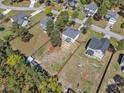 Aerial view of a residential neighborhood showcases the property's large, fenced-in backyard with mature trees at 78 Parkview Ln, Lillington, NC 27546