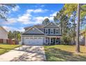 Charming two-story home with a well-manicured front yard, two car garage, and an inviting front porch in the daytime at 78 Parkview Ln, Lillington, NC 27546