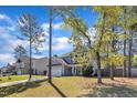 Charming two-story home with a well-manicured front yard, two car garage, and an inviting front porch at 78 Parkview Ln, Lillington, NC 27546