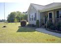 Landscaped front yard showcasing the entrance, green lawn, and curb appeal of the home at 860 Bear Rd, Benson, NC 27504