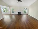 Spacious living room with hardwood floors, fireplace, and ample natural light at 10 Cricket Hollow Run, Clayton, NC 27520