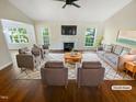 Bright and inviting living room with fireplace, ample seating, and large windows at 10 Cricket Hollow Run, Clayton, NC 27520