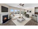 Bright living room with a fireplace, modern furnishings, and ample natural light from large windows at 1019 Thoughtful Spot Ln, Durham, NC 27703