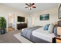 Spacious main bedroom boasts a comfortable bed, ample lighting, and a view to the bathroom at 1019 Thoughtful Spot Ln, Durham, NC 27703