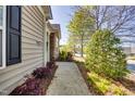 Home exterior with stone accents, siding, and a well-manicured walkway at 1064 Blue Bird Ln, Wake Forest, NC 27587