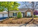 Charming home showcasing siding, stone accents, and well-maintained front yard landscaping at 1064 Blue Bird Ln, Wake Forest, NC 27587