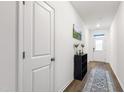Bright entryway with hardwood floors, white walls, and decorative accents. A lovely welcome to the home at 124 Alta Crest Ln, Garner, NC 27529