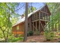 Stunning view of the back exterior featuring a screened porch on a wooded lot at 1355 Bowling Road, Fuquay Varina, NC 27526