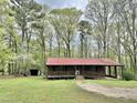 Charming brick home featuring a covered porch and well maintained lawn at 1622 N Carolina 98 Hwy W, Louisburg, NC 27549