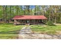 View of charming brick home featuring a covered porch and well maintained lawn at 1622 N Carolina 98 Hwy W, Louisburg, NC 27549