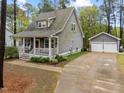 Two-story home features a welcoming front porch and a detached two-car garage at 2007 Watson Rd, Durham, NC 27704