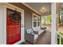 Welcoming front porch with comfortable seating and a red front door at 2007 Watson Rd, Durham, NC 27704