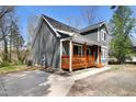 Exterior showcasing a covered porch with wood railing, and a concrete driveway at 218 Archdale Dr, Durham, NC 27707