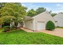 Charming home with a one-car garage, a well-maintained lawn, and mature landscaping at 227 Chimney Rise Dr, Cary, NC 27511
