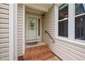 Inviting front entrance with brick steps and decorative glass storm door at 227 Chimney Rise Dr, Cary, NC 27511