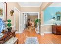 Inviting foyer with hardwood floors, soft, neutral paint, and elegant decor setting a tone of sophisticated charm at 255 Williamston Ridge Dr, Youngsville, NC 27596