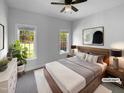 Cozy bedroom features neutral decor, two windows with outdoor views, and a ceiling fan at 30 Alvis Ct, Fuquay Varina, NC 27526