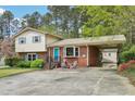 Inviting brick home with covered carport, mature trees, and well-maintained landscaping at 3011 Kenan Rd, Durham, NC 27704