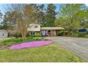 Two-story home with blooming flowers, manicured lawn, and covered carport at 3011 Kenan Rd, Durham, NC 27704