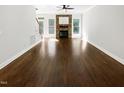 Spacious living room featuring hardwood floors, a fireplace and a ceiling fan at 3638 Pine Needles Dr, Wake Forest, NC 27587