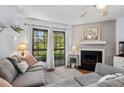 Cozy living room with a fireplace, plush seating, and a balcony offering outdoor views at 3805 Chimney Ridge Pl # 003, Durham, NC 27713