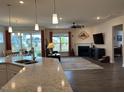 Spacious living area with a fireplace, and seamless flow from the kitchen at 4118 Rillcrest Grove Way, Fuquay Varina, NC 27526