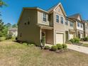 Side view of townhome showing the yard and concrete driveway and neighboring townhomes at 4901 Rose Quartz Way, Raleigh, NC 27610