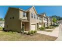 View of well-maintained townhomes with neatly landscaped yards and concrete driveways at 4901 Rose Quartz Way, Raleigh, NC 27610