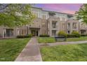 Attractive condo building with manicured lawn, walkway, and bench offers a comfortable and inviting place to live at 501 Finsbury Street # 103, Durham, NC 27703