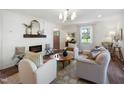Bright living room with hardwood floors, fireplace, stylish furnishings, and lots of natural light at 511 Circle Dr, Burlington, NC 27215
