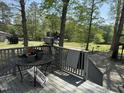Outdoor deck with seating offering views of the grassy backyard at 5138 Nc 56, Franklinton, NC 27525