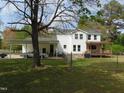 Spacious backyard featuring a covered carport, patio, and fenced yard, perfect for outdoor activities at 5531 Autry Rd, Rocky Mount, NC 27803