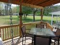 Inviting outdoor deck with dining set, ideal for entertaining or relaxing with a view at 5531 Autry Rd, Rocky Mount, NC 27803