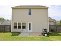 Exterior photo of home's rear facade featuring a door, windows, patio, grill, and grassy yard at 624 S Kennelman Cir, Wendell, NC 27591