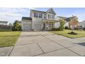 Beautiful two-story home with a well-kept lawn and a spacious driveway leading to a two-car garage at 624 S Kennelman Cir, Wendell, NC 27591