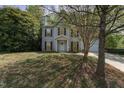 Charming two-story home features a manicured front yard and attached garage at 9904 Erinsbrook Dr, Raleigh, NC 27617