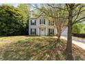 Charming two-story home features a manicured front yard and attached garage at 9904 Erinsbrook Dr, Raleigh, NC 27617