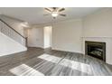 Open-concept living room featuring a fireplace, ceiling fan, and wood-look floors at 0 Hwy 86, Cedar Grove, NC 27231