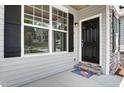 Inviting front entrance with stylish black door, stone accents, and well-maintained landscaping at 0 Sawmill, Cedar Grove, NC 27231