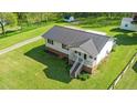 Home with a metal roof, spacious yard, storage shed, and back deck at 1017 S Second Ave, Siler City, NC 27344