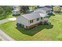 Aerial view of the house showcasing its metal roof, well-maintained lawn, and backyard shed at 1017 S Second Ave, Siler City, NC 27344