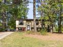 A charming single-Gathering home sits among lush trees and a sprawling green lawn at 103 Wesker Cir, Durham, NC 27703