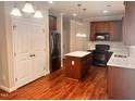 Kitchen featuring wood flooring, stainless steel appliances, and white double door pantry at 104 Mainline Sta, Morrisville, NC 27560